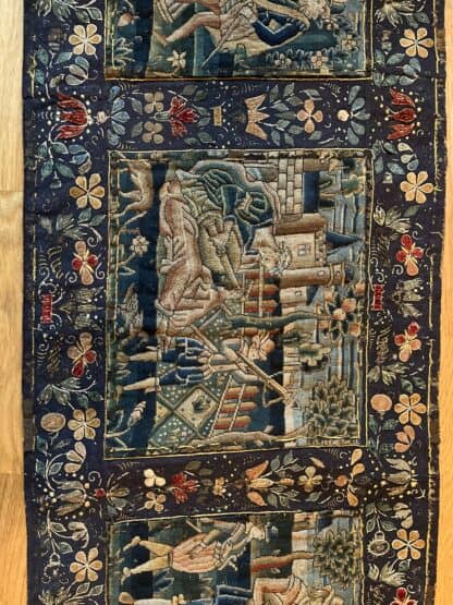 Third panel of the needlework, showing a man with a crossbow and another playing the lute