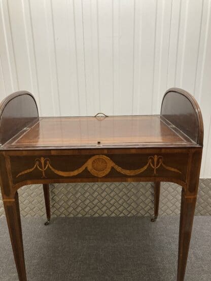 Front view of desk, with tambour open and writing pad laying flat